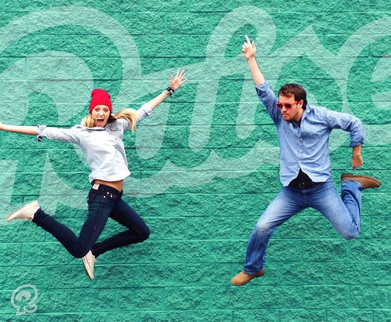 People jumping in front of Raise wall.